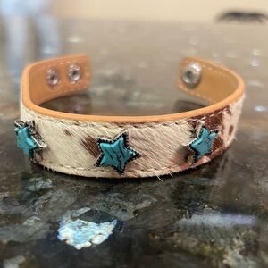 Cow hide star bracelet 
Very cute!